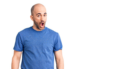 Fototapeta premium Young handsome man wearing casual t shirt afraid and shocked with surprise expression, fear and excited face.