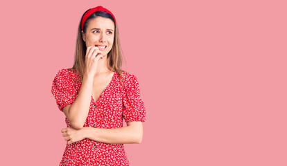 Young beautiful girl wearing dress and diadem looking stressed and nervous with hands on mouth biting nails. anxiety problem.