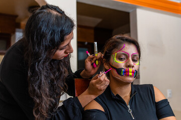 woman putting makeup on another woman