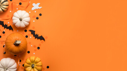 Halloween creative flat lay composition. Celebration decorations, bats, pumpkins and ghost on...