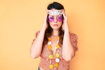 Young beautiful brunette woman wearing bohemian and hippie style with hand on head, headache because stress. suffering migraine.