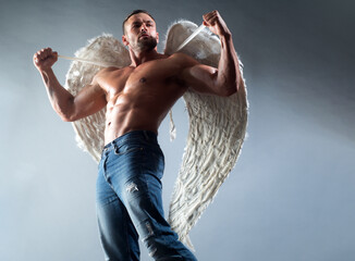 Muscular male model. Man with angels wings.