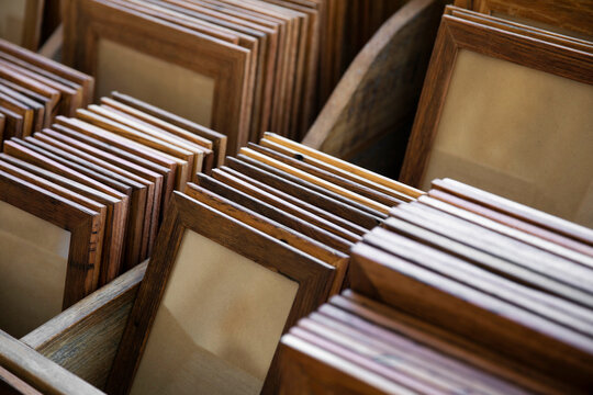 Groups of handmade wooden picture frames organised into groups by size and type of treatment.