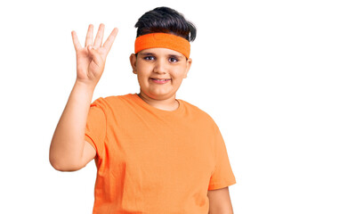 Little boy kid wearing sportswear showing and pointing up with fingers number four while smiling confident and happy.