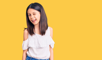 Obraz premium Beautiful child girl wearing casual clothes winking looking at the camera with sexy expression, cheerful and happy face.