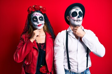 Couple wearing day of the dead costume over red touching painful neck, sore throat for flu, clod and infection