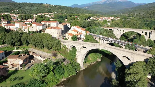 General view from drone of Ceret town on banks of river Tech in foothills of Pyrenees mountains in summer, France