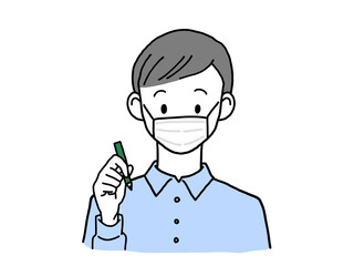 ペンを持つマスク姿の若い男性