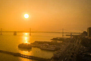 Eerie orange sky over Bay Bridge in San Francisco, drone image