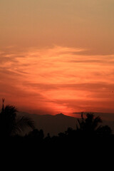 Beautiful sunset with the silhouette of coconut trees