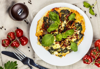 small pizza with tomatoes and basil