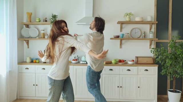 Lovely Couple Having a Fun Together While Dancing at the Bright Kitchen.