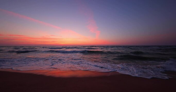 Ocean beach sunrise and dramatic colorful sky clouds