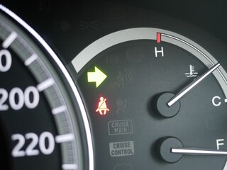 car turning signal light on car dashboard.
