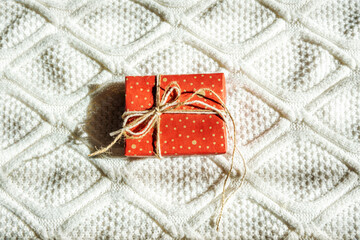 Red mittens and white knitted sweater.