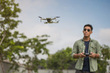 Drone operated by man on outdoor. Drone pilot.