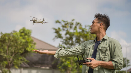 Man operating drone by remote control. Drone Pilot.