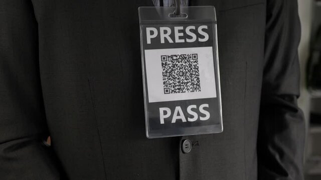 Journalist wearing a press pass to identify himself.