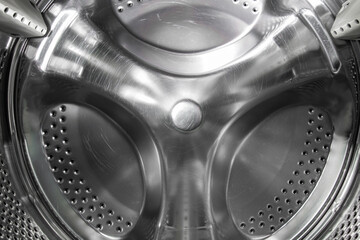 Inside the drum of an old washing machine. Scratches on the drum of a broken washing machine....