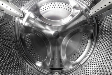 Inside the drum of an old washing machine. Scratches on the drum of a broken washing machine....