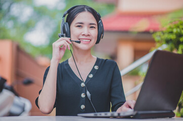 Asian women working from home by head phone call center