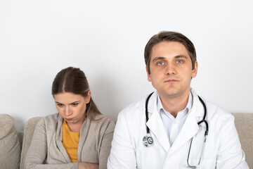 Fototapeta premium Doctor consulting female patient at home