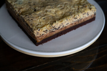 Overhead view of  white  chocolate cake on a white plate.