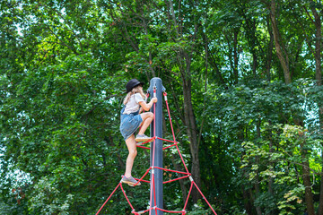 child climbing rope playground