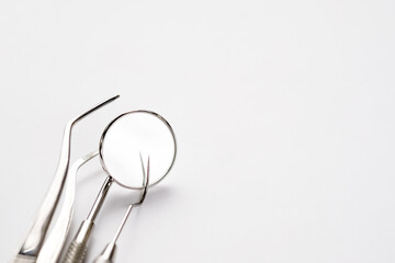 Basic dentist tools on white background.
