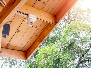 CCTV camera on wood ceiling.