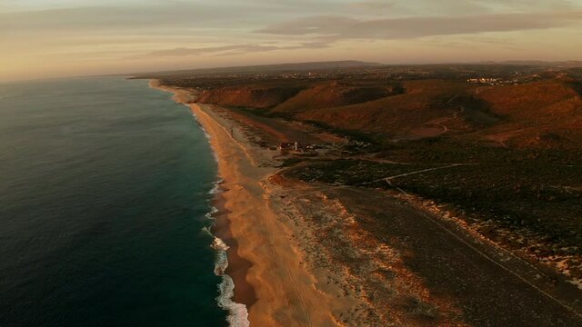 Establishing shot of a beautiful beach at sunset.