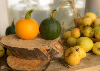 composition of small pumpkins and apples, wooden disc base, Halloween time