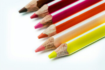 Obraz premium colored pencils row on white background