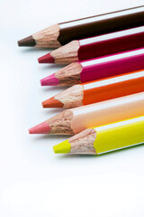 colored pencils row on white background