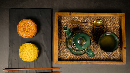 Moon cake with tea. Chinese celebration and asian tradition. Baked oriental pastry for mid autumn.