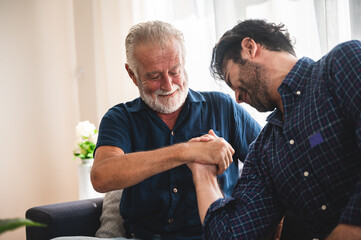 Fototapeta premium Quarantine time: Happy family son and dad at living room together to play music.