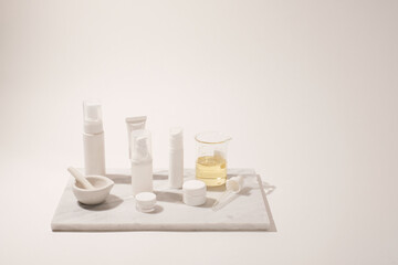 cosmetic and skin care for beauty routine on white background with shadow. modern and minimal product design with essential oil, pestle and mortar.
