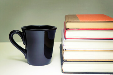 Fototapeta na wymiar pile of books and cup