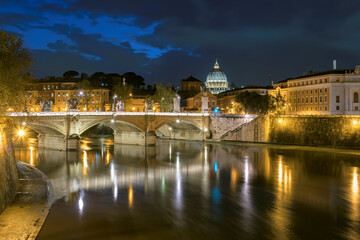 Rome at night, Italy. Dome of Saint Peter Basilica in Vatican city and Sant Angelo Bridge,...