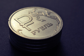 Russian 1 one ruble coin with the official symbol of the national currency on a dark background....