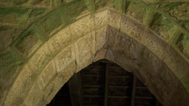 Arched doorway entrance on old stone building medium panning shot