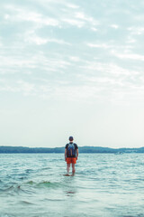 man standing in the sea water at beach