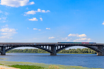 View of Metro bridge with subway train passing and the Dnieper river in Kiev, Ukraine