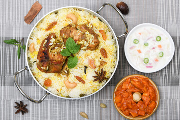 Chicken biryani. Spicy Indian Malabar biryani or Hydrabadi biryani, Dum Biriyani,  fish and rice. pulao basmati rice, spicy mixed rice dish with meat curry for Ramadan Kareem, Eid