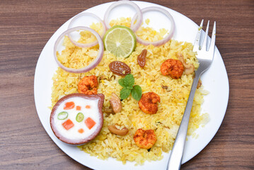 Prawns fish biryani. Spicy Indian Malabar biryani or Hydrabadi biryani, Dum Biriyani,  fish and rice. pulao basmati rice, spicy mixed rice dish with meat curry for Ramadan Kareem, Eid
