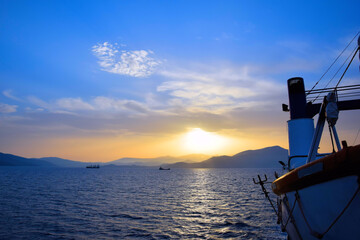 Fototapeta na wymiar cargo ship travels at sunset