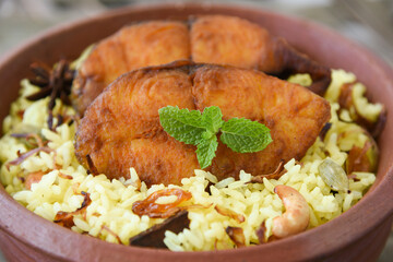 Fish biryani. Spicy Indian Malabar biryani or Hydrabadi biryani, Dum Biriyani,  fish and rice. pulao basmati rice, spicy mixed rice dish with meat curry for Ramadan Kareem, Eid