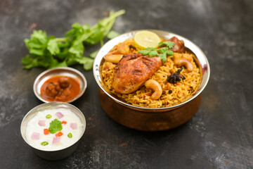 Chicken biryani. Spicy Indian Malabar biryani or Hydrabadi biryani, Dum Biriyani,  fish and rice. pulao basmati rice, spicy mixed rice dish with meat curry for Ramadan Kareem, Eid