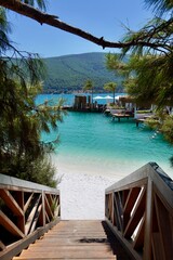 Stairs to the Paradise. Advertising holiday banner Lux. Stairs descend to a very beautiful protected beach with white sand and pure emerald water. CLOSE UP: Scenic stairwell offers a breathtaking view