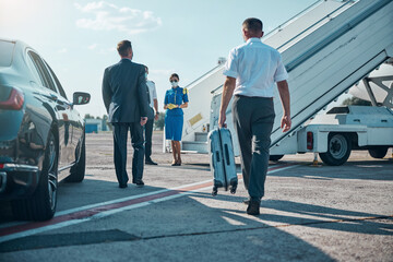 Jet staff meeting businessman with assistant on runway